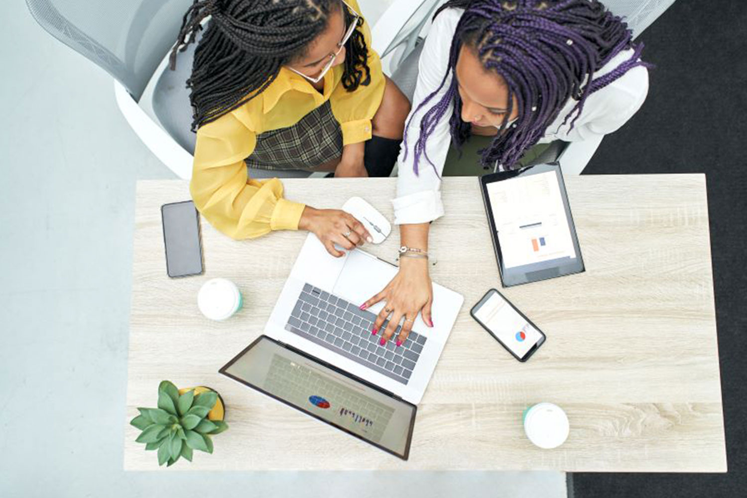 two African American women on a laptop
